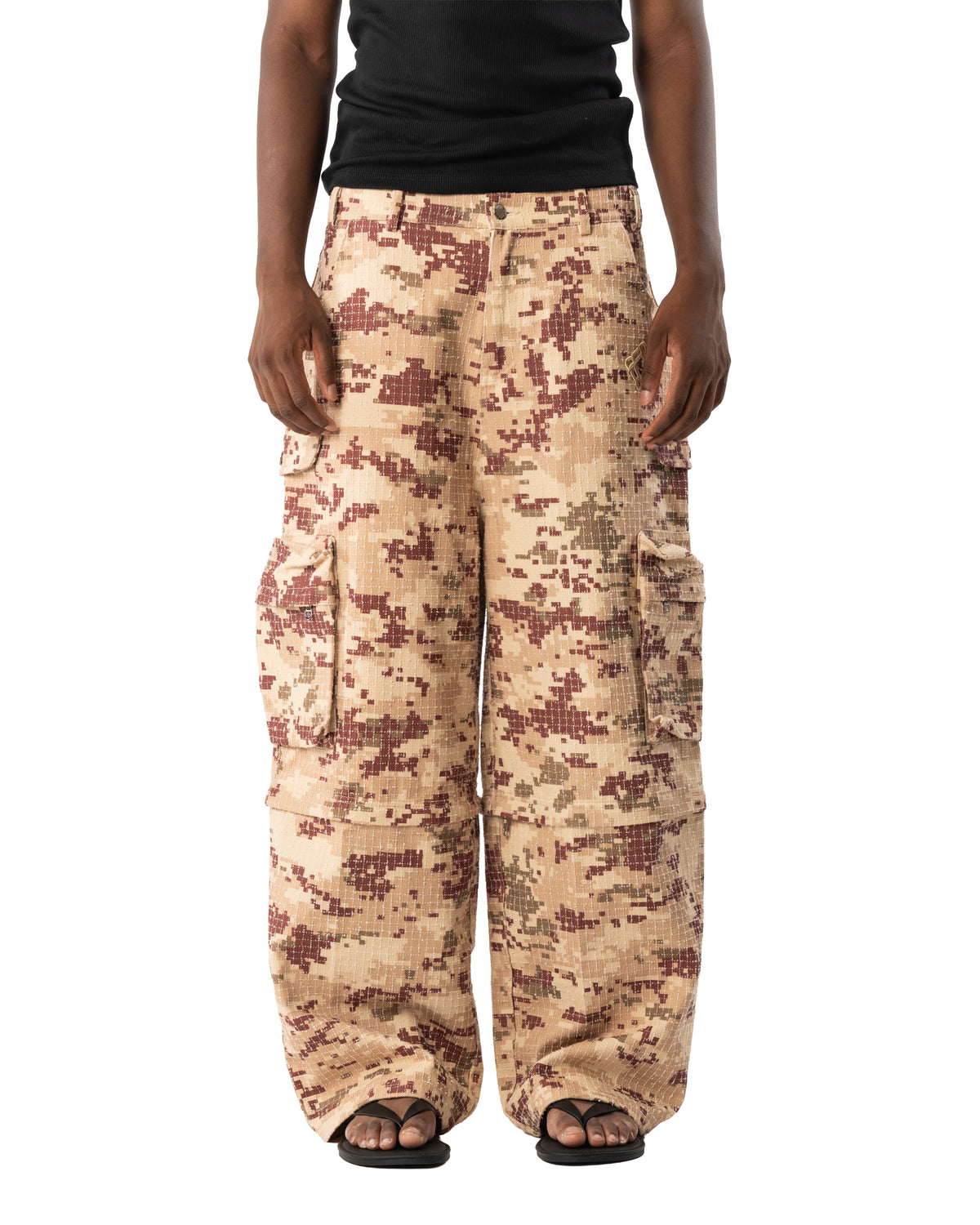 Front view of beige pixel-camo 2-in-1 cargo pants with detachable leg panels attached